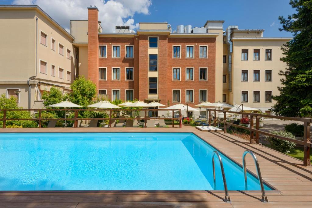 a pool at a hotel with buildings in the background at Occidental Aurelia in Rome