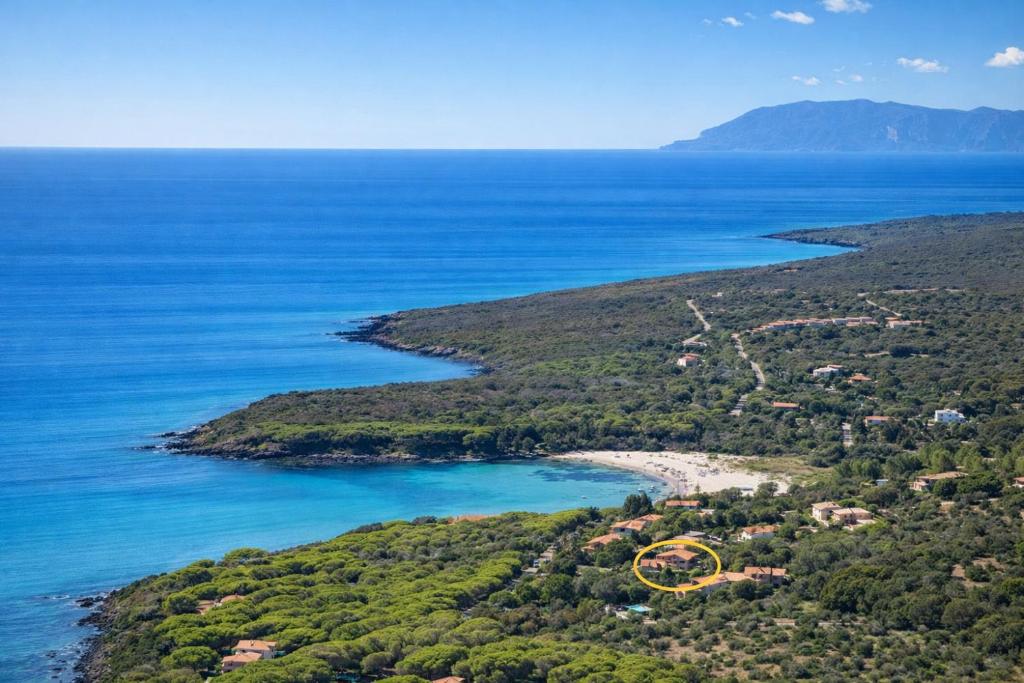 an aerial view of a small island with a yellow house at Hotiday Orosei Fuile e Mare in Orosei