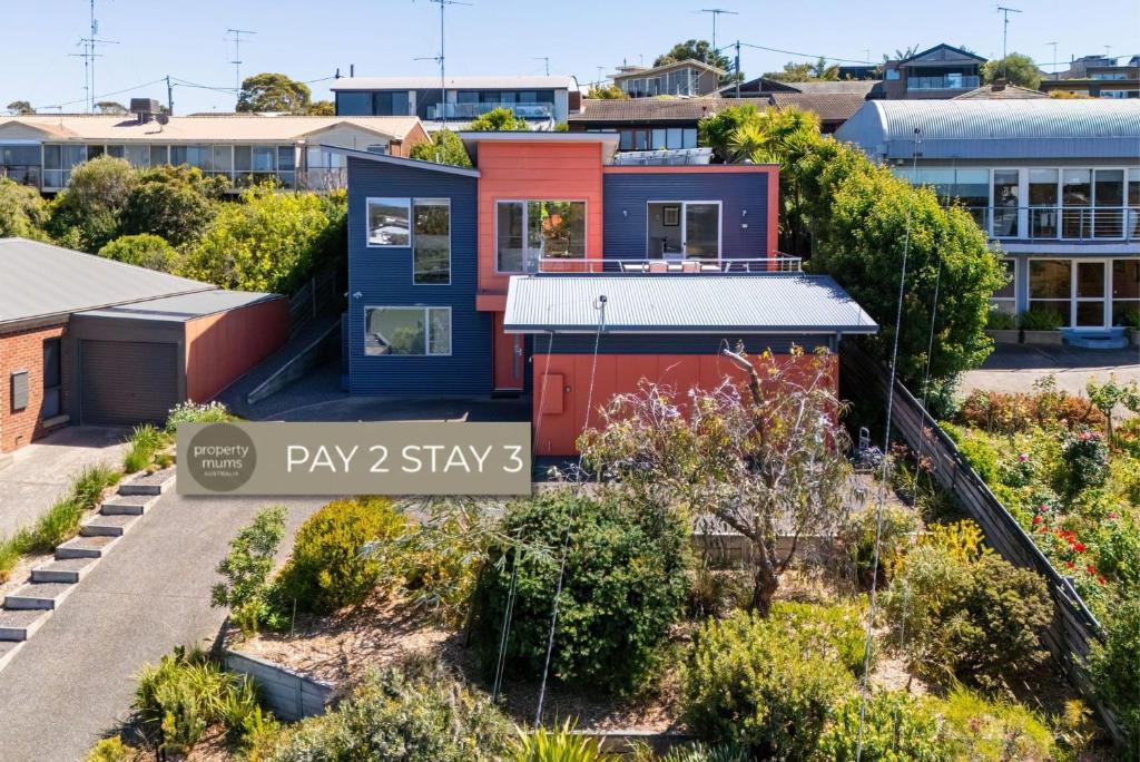 a house in a city with a sign that says play stays at Blue Horizons at Ocean Grove in Ocean Grove
