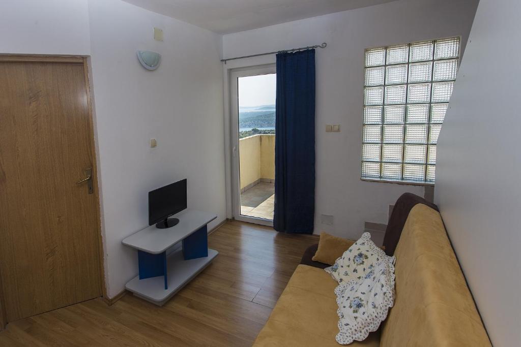 Televízia a/alebo spoločenská miestnosť v ubytovaní Gospodar Apartments