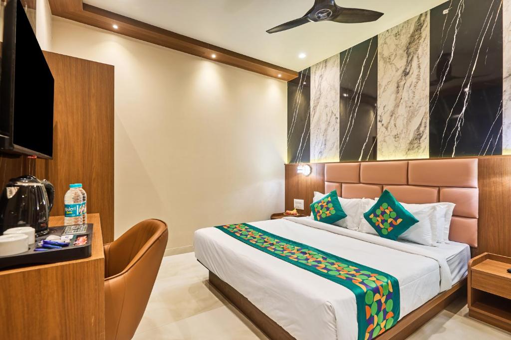 a hotel room with a bed and a television at Treebo Amber International Mumbai Airport T2 in Mumbai