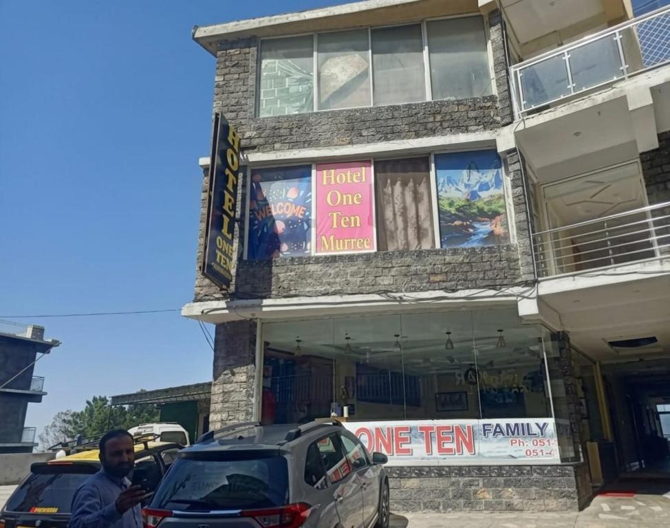 a man standing in front of a one item store at Hotel One Ten Mall Road Murree in Murree