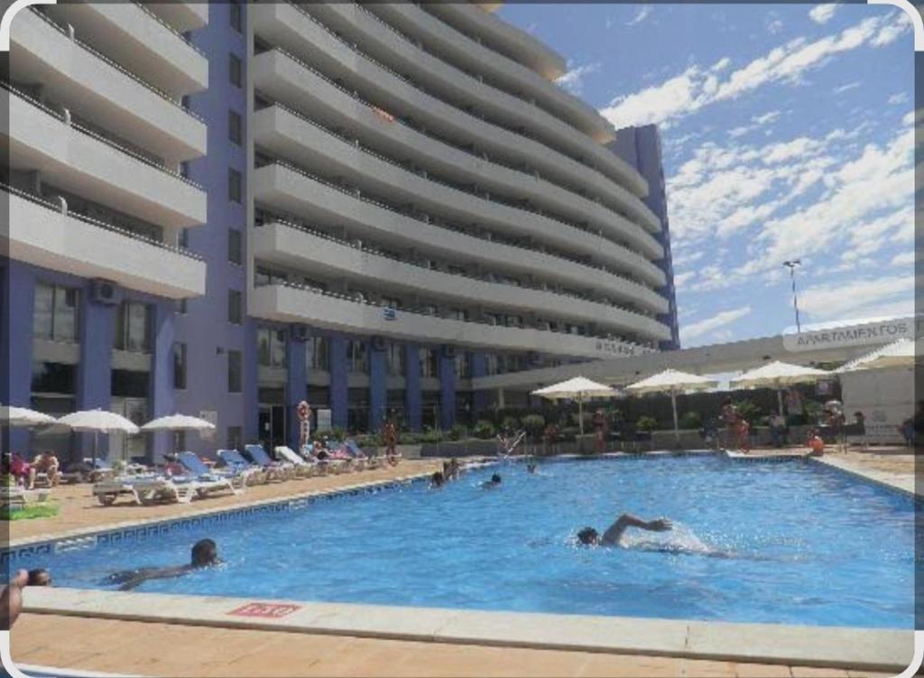 a group of people in a swimming pool in a building at Space atlantic 1 in Portimão