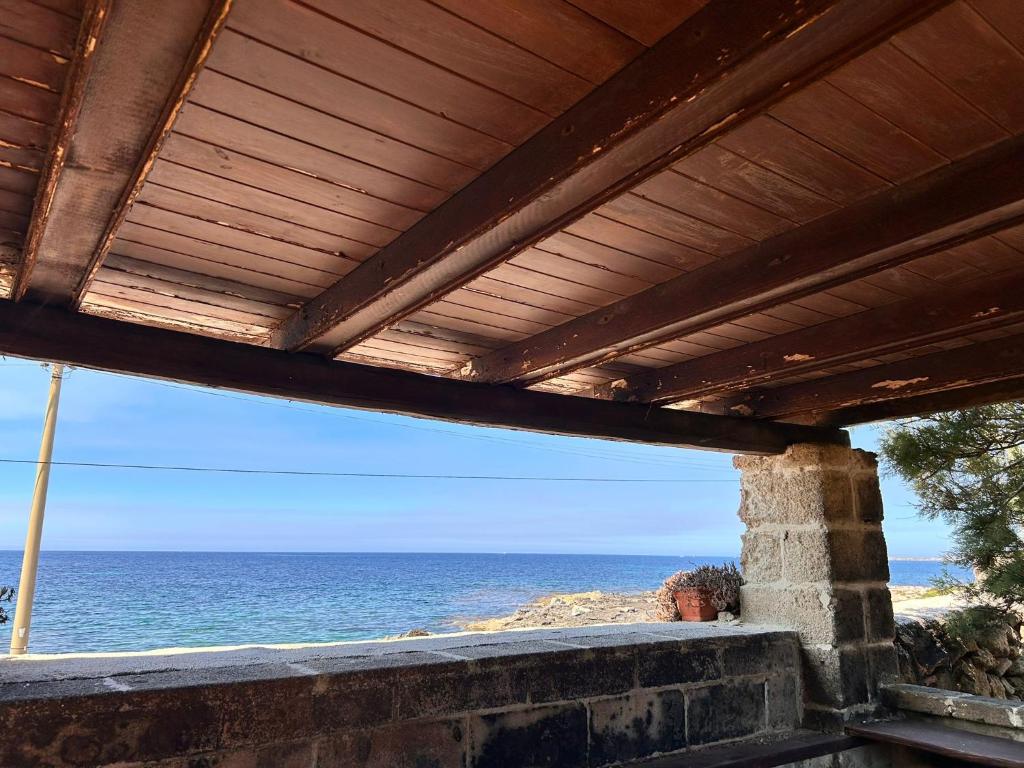 a view of the ocean from a building with a wooden roof at Il Villaggetto sul Mare in Favignana