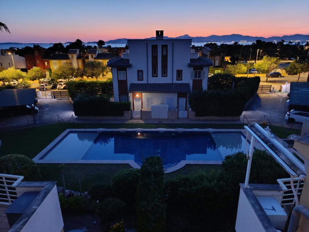 a villa with a swimming pool at dusk at Son Veri LUXURy HOME in Cala Blava