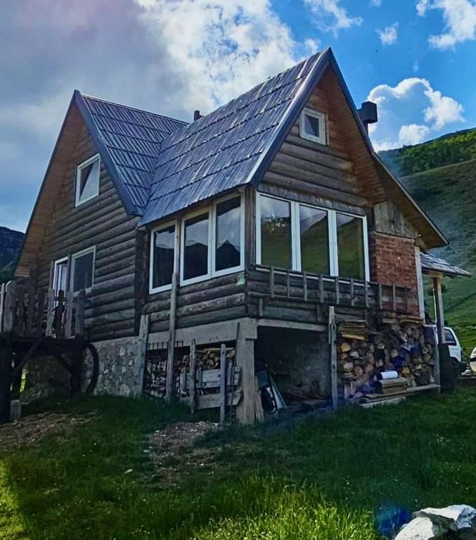 a house with a solar roof on top of it at Mirno mjesto in Mujakovići