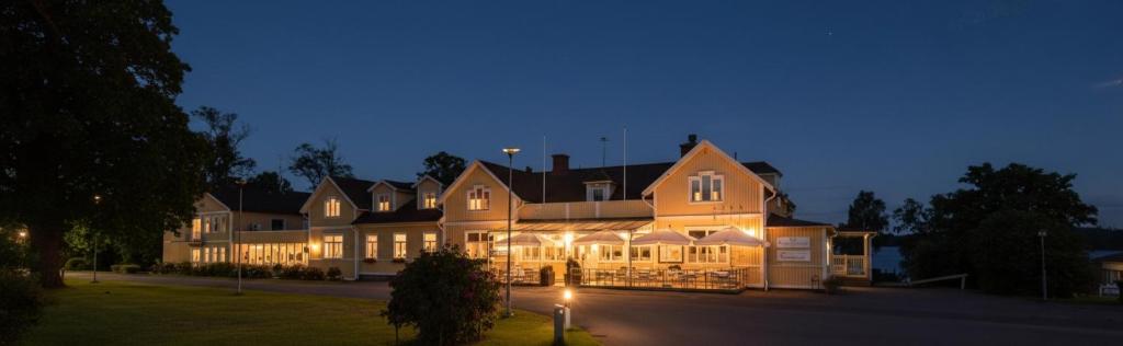 a large building with lights on it at night at Gränna Strandhotell in Gränna