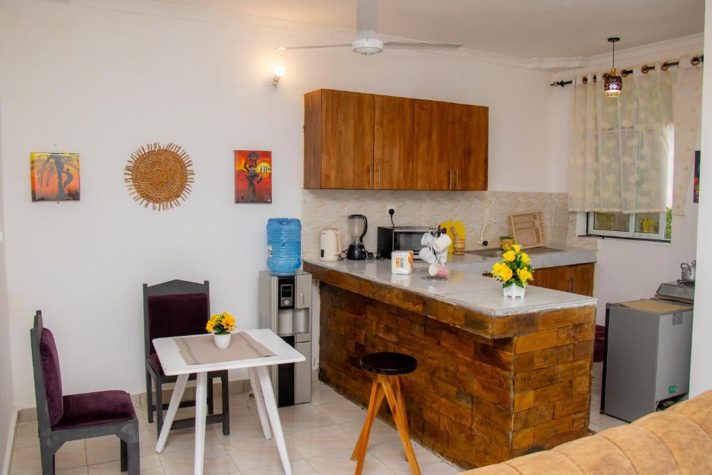 a kitchen with a counter and a table in a room at Bamburi BnB in Mombasa