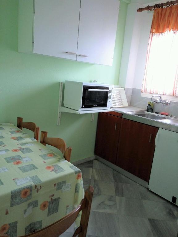 Kuchyň nebo kuchyňský kout v ubytování Grivas Apartments