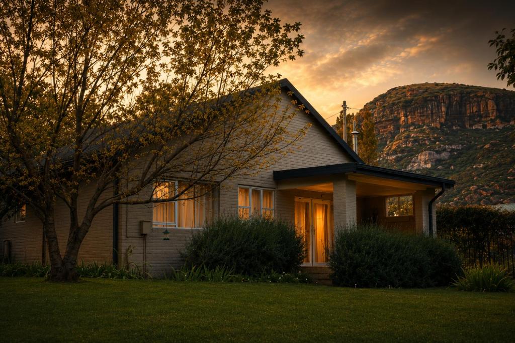a house with a mountain in the background at Upper House Boutique Guesthouse in Clarens