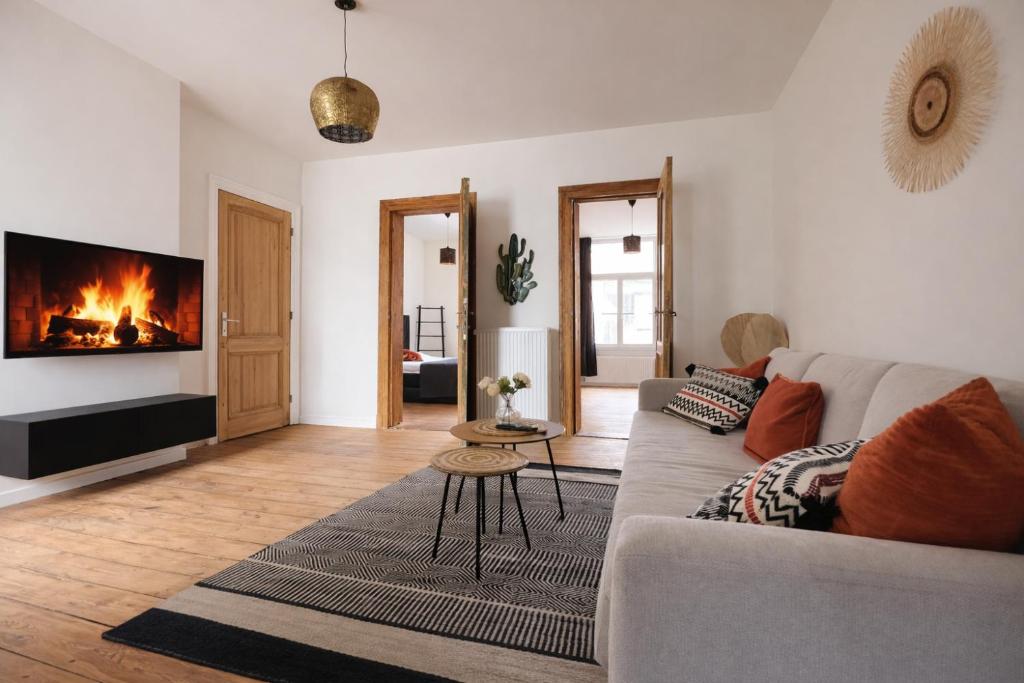 a living room with a couch and a fireplace at Boho Apartments - 2 Bedrooms in Antwerp