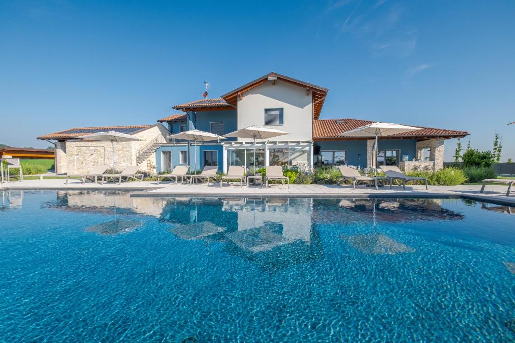 a swimming pool in front of a house at Villa Sarmassa in Narzole