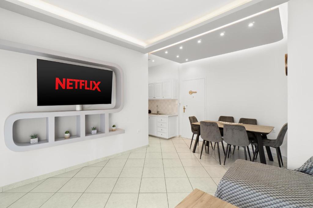 a living room with a tv on a wall at Minimal Stay House in Petalidi