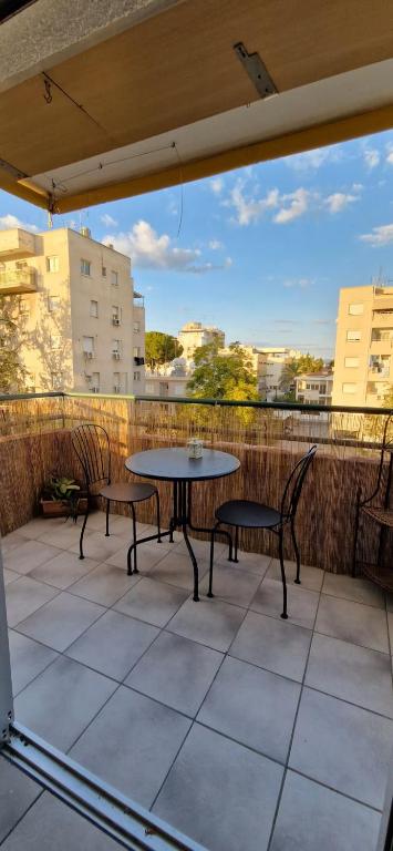 a patio with two chairs and a table on a balcony at Spacious Central Nicosia Flat - Quiet & SafeArea in Nicosia