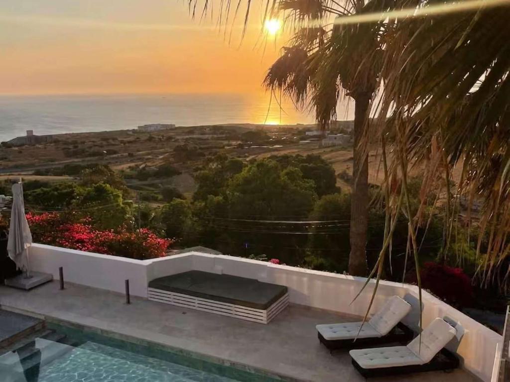 a villa with a pool and a view of the ocean at The Homega Villa in Il-Madliena