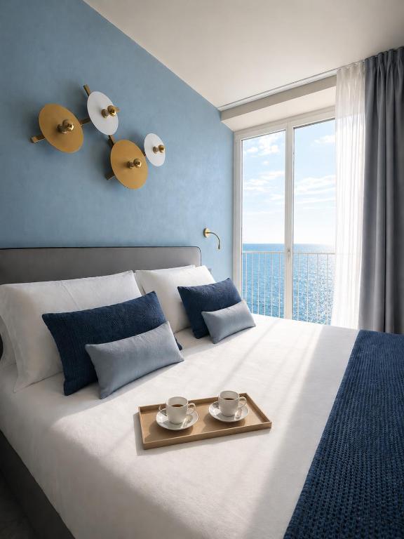 a bedroom with a large bed with a tray on it at Boutique Hotel Alassio in Alassio