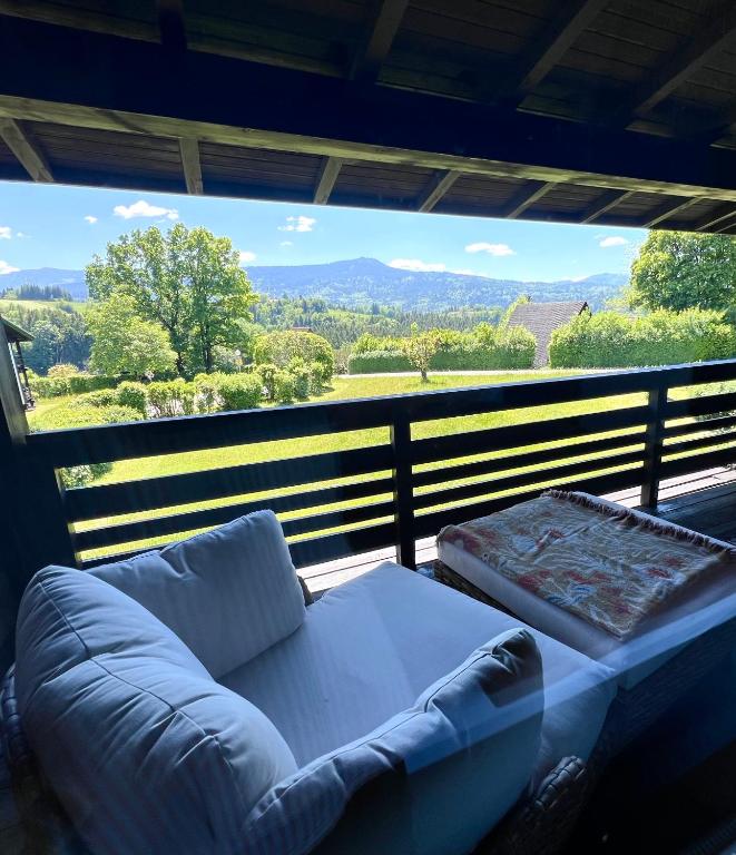 a couch sitting on a balcony with a view at Chiemgau Nest II in Siegsdorf