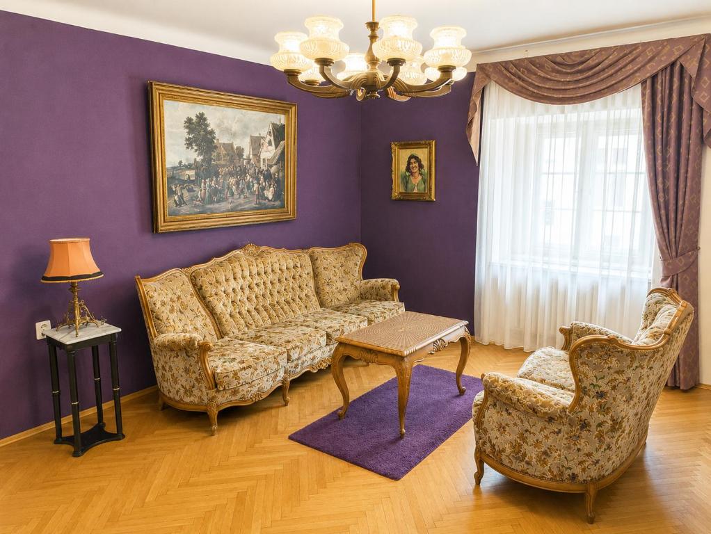 a living room with a couch and two chairs at Astronomical Clock Apartment in Prague
