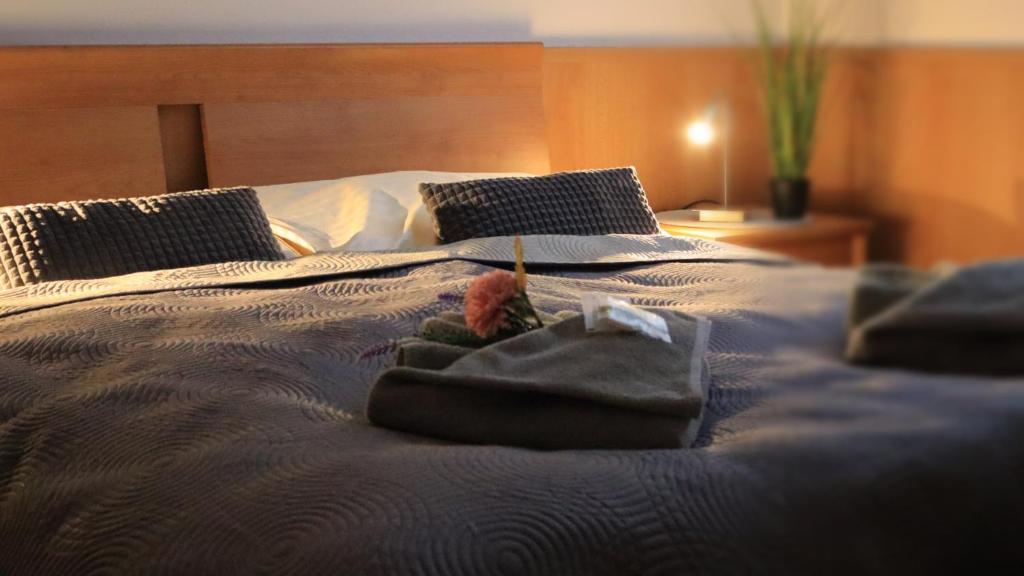 a bed with towels and pillows on it at Ubytovanie KRAS in Rožňava