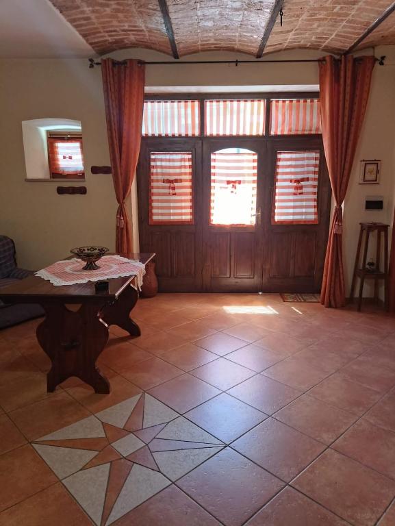 a living room with a table in front of a door at Il Rustico in Celano