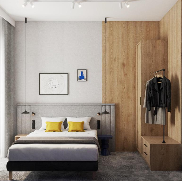 a bedroom with a bed with yellow pillows at Cobalt36 in Bolesławiec