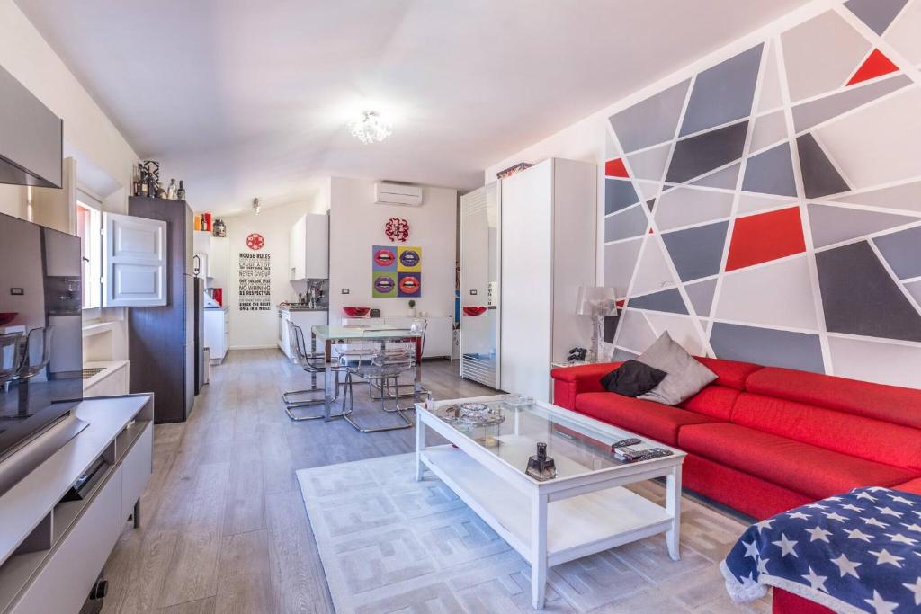 a living room with a red couch and a table at De' Fusari, Bologna by Short Holidays in Bologna