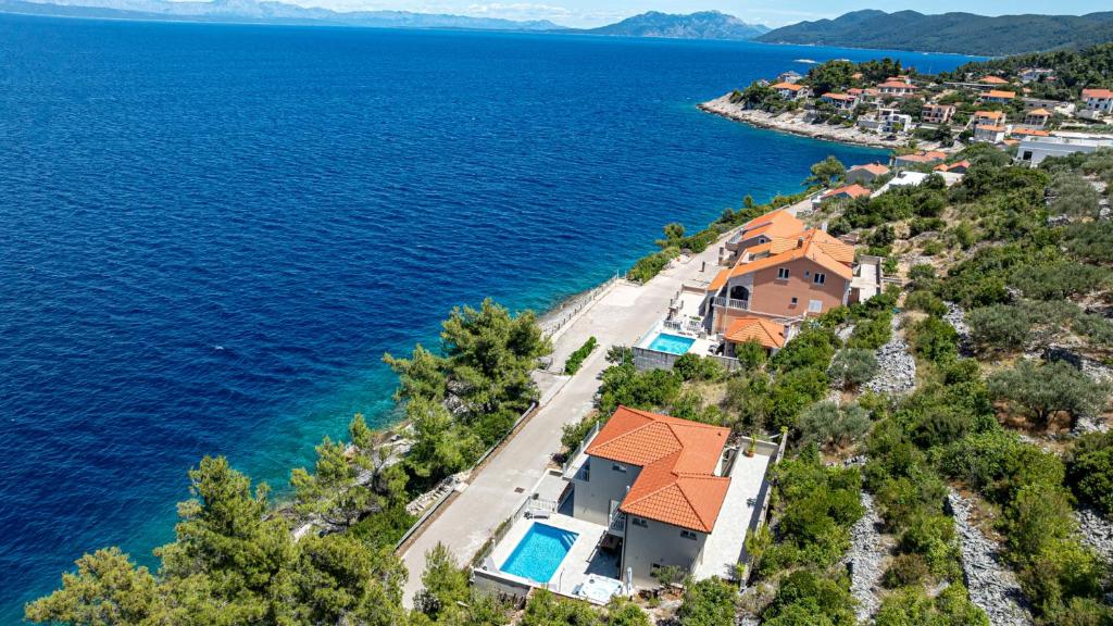 an aerial view of a house on a hill next to the water at Villa Antonia by Villas Guide in Blato