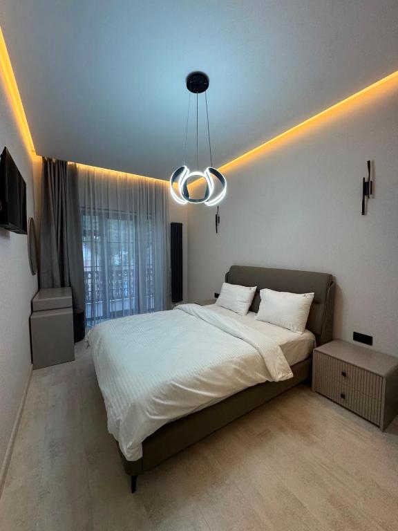 a bedroom with a large white bed with a light at Sargsyans house in Dilijan