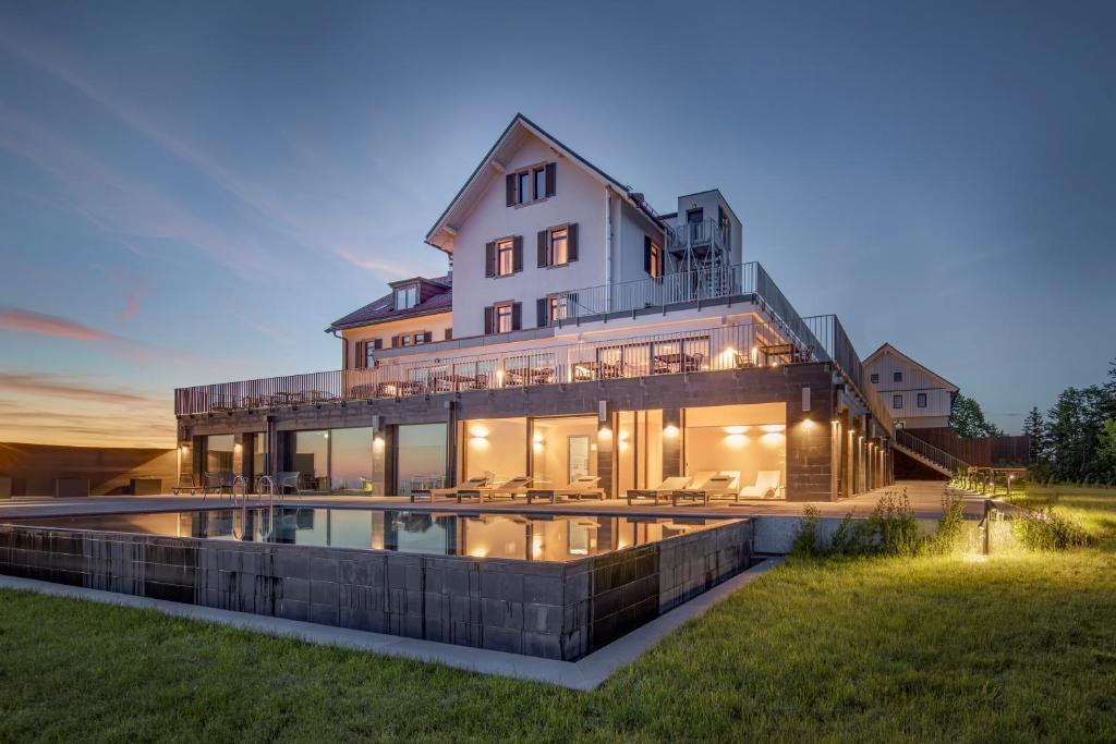 a large house with a pool in front of it at Hochblauen Hotel in Badenweiler