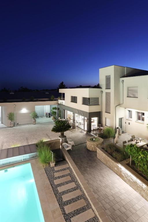 a villa with a swimming pool at night at Ferienwohnung Königshofer in Neusiedl am See