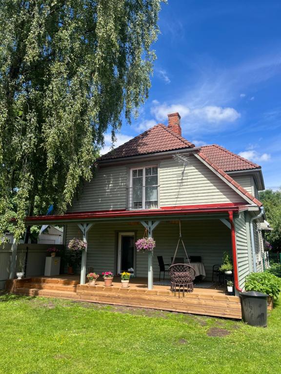a house with a deck with a bench on it at Vase Holiday Home in Tartu