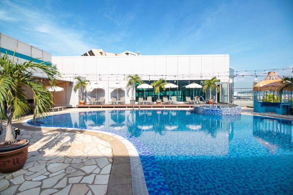 a large swimming pool in front of a building at Changi Transit Hotel Terminal 1 in Singapore