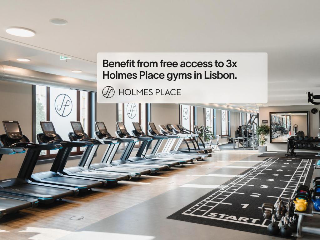 A spacious, bright gym with a long treadmill row and functional-training area.