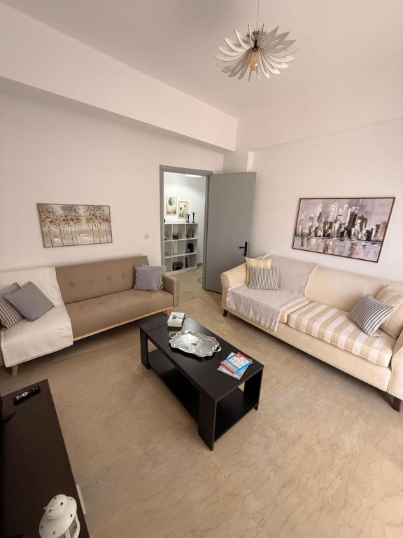 a living room with two couches and a coffee table at Methoni Joanna House in Methoni