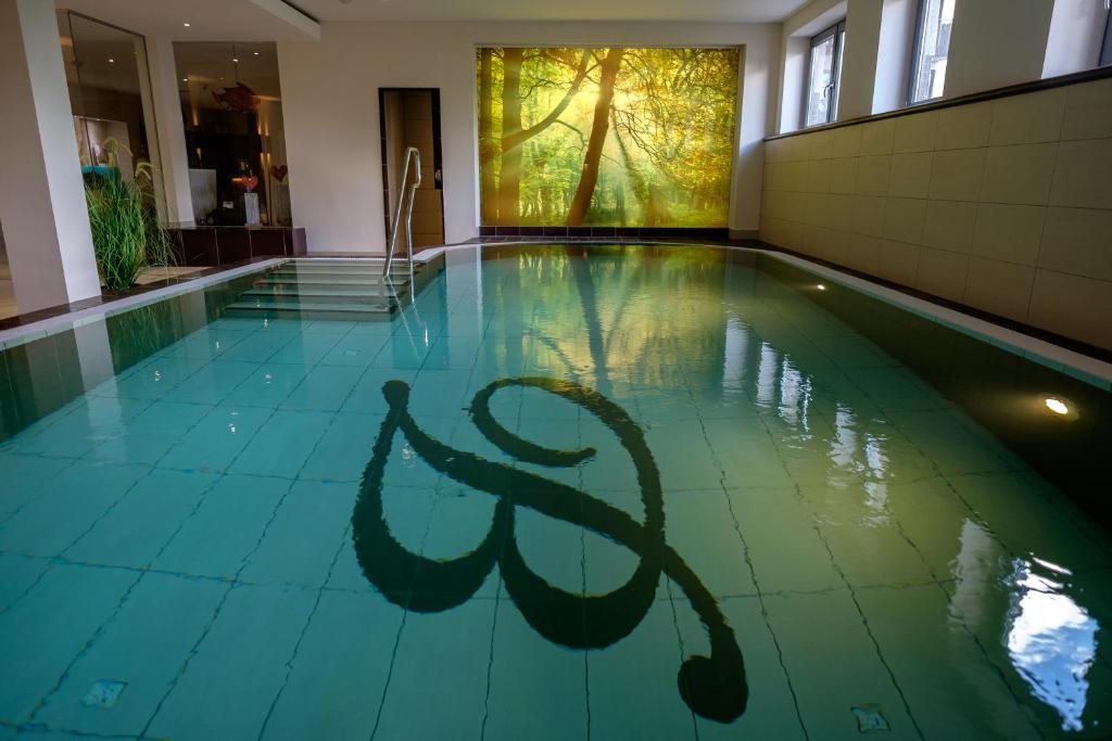 a swimming pool with a logo on the floor at Walpurgishof in Hahnenklee-Bockswiese