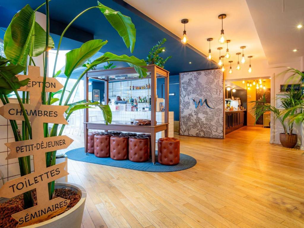 a store with plants in the middle of a room at Mercure Paris Montparnasse Pasteur in Paris