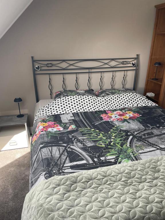 a bedroom with a bed with a bicycle blanket at Homestay Bij de Heldinnen in Helden