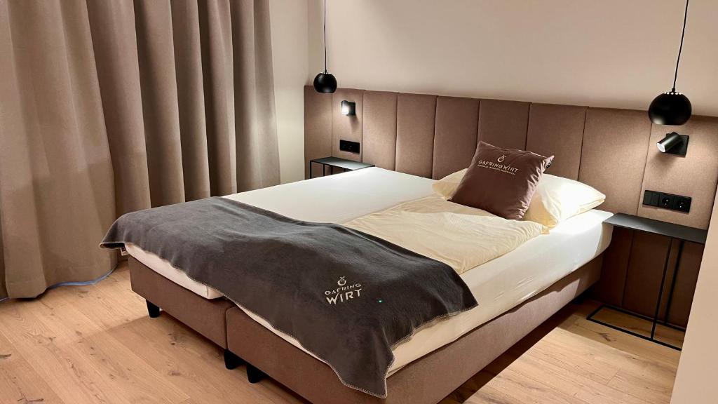 a bedroom with a large bed with a headboard at Landhotel Gafringwirt in Euratsfeld