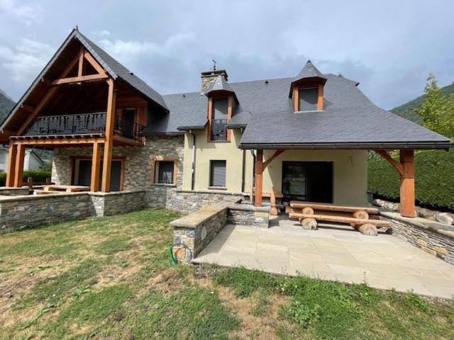 a house with a bench in front of it at Châlet Haut de Gamme Pyrenees in Guchan