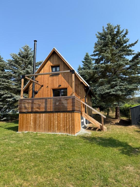 a large wooden house on a field with trees at Natka a Ratka in Louka