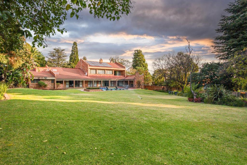 a house on a large grassy yard with a golf ball at Bryanston stays in Johannesburg