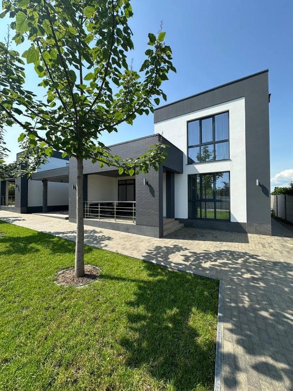a house with a tree in front of it at Relax Lux in Mykolaivka