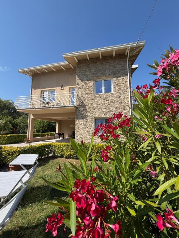 a house with pink flowers in front of it at Pratelli B&B in Saludecio