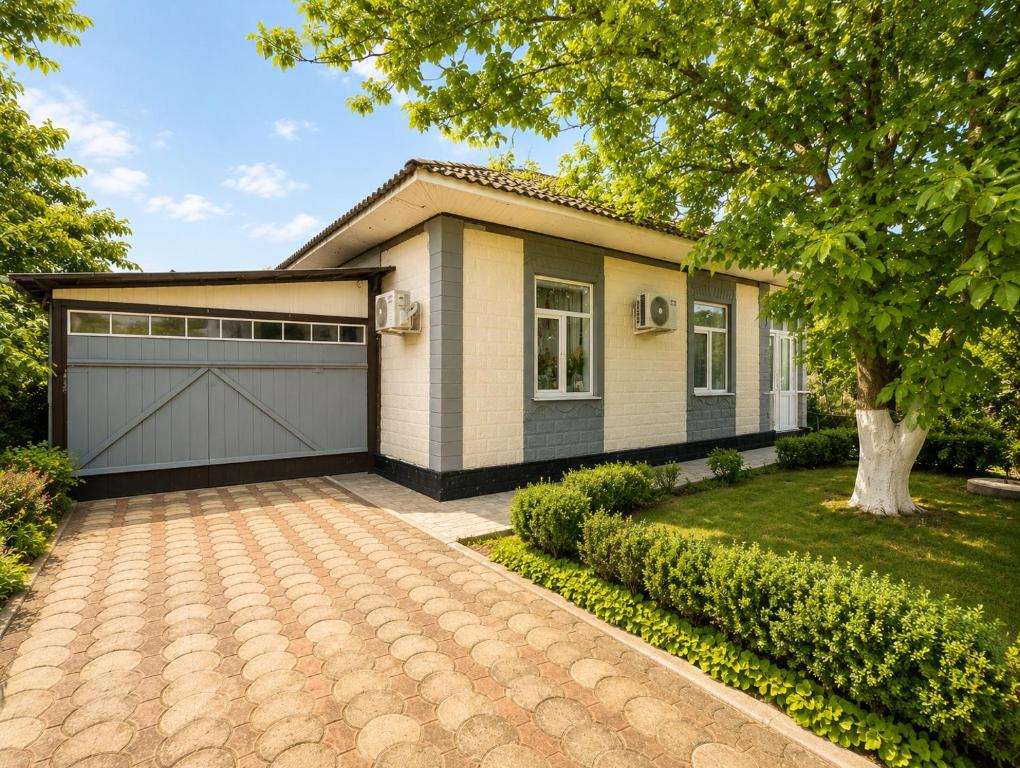 a house with a garage and a driveway at Apartment Casa de Bruja in Drochia