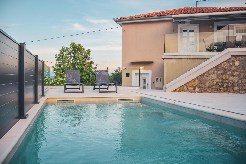 a swimming pool in the backyard of a house at Apartments Petra in Risika
