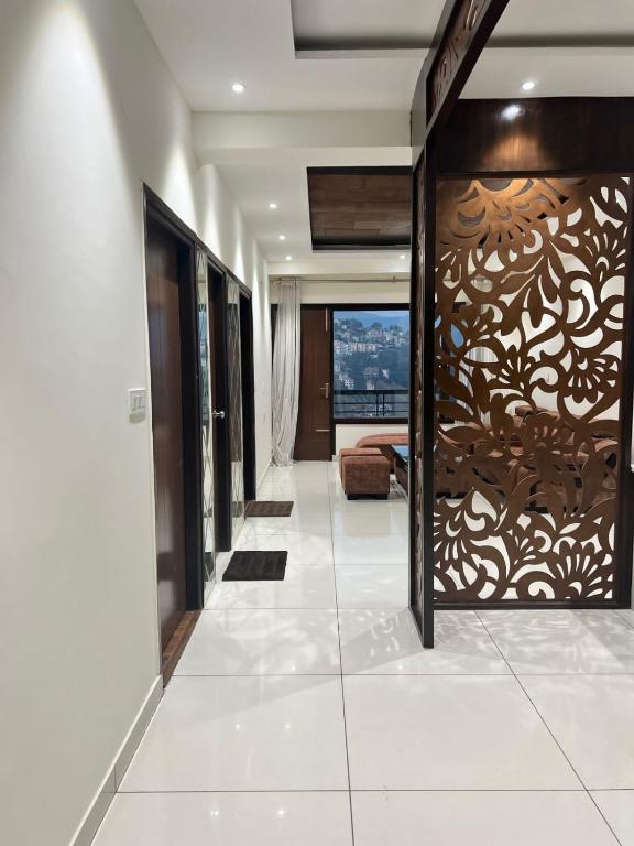 a hallway with a sliding glass door with a wall mural at Potion's Villa - Shimla in Shimla