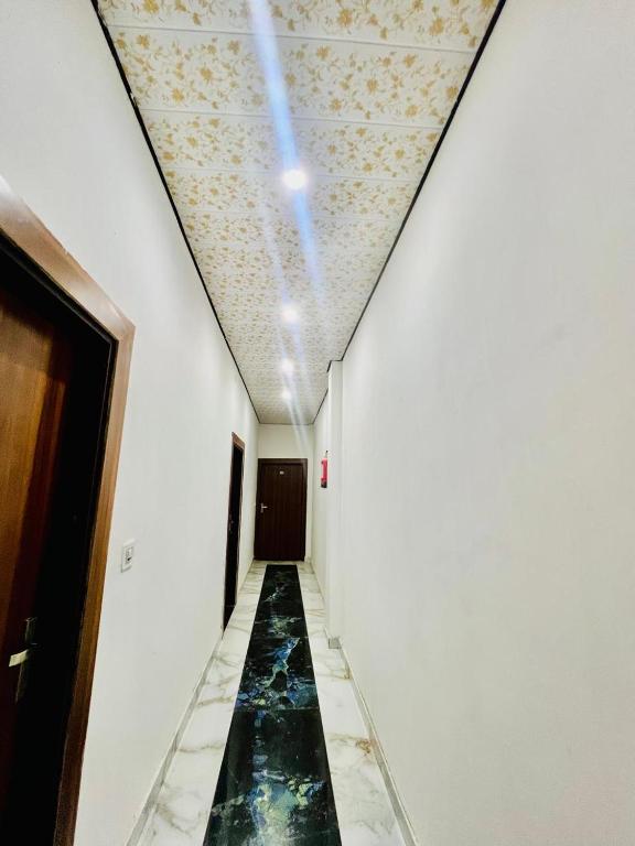 a long hallway with a pool of water on the ceiling at Hotel Jazz Suit Villa in Agra