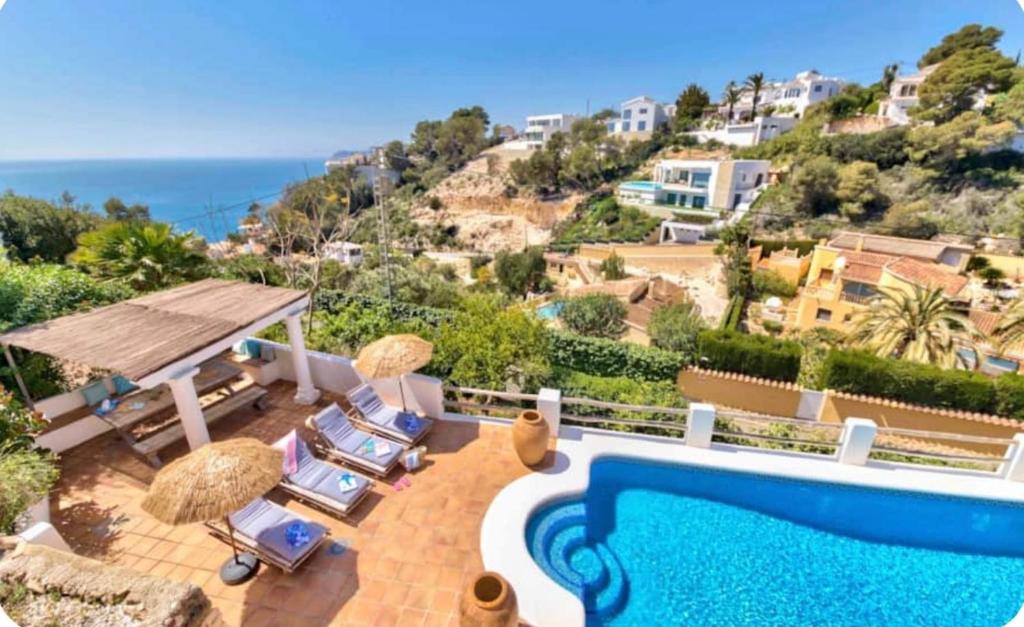 a villa with a swimming pool and a view of the ocean at Villa Granadella in Jávea