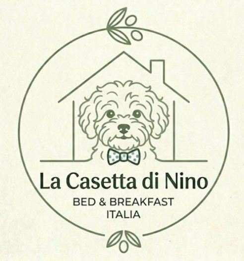 a logo of a dog with a bow tie at La casetta di Nino in Termoli