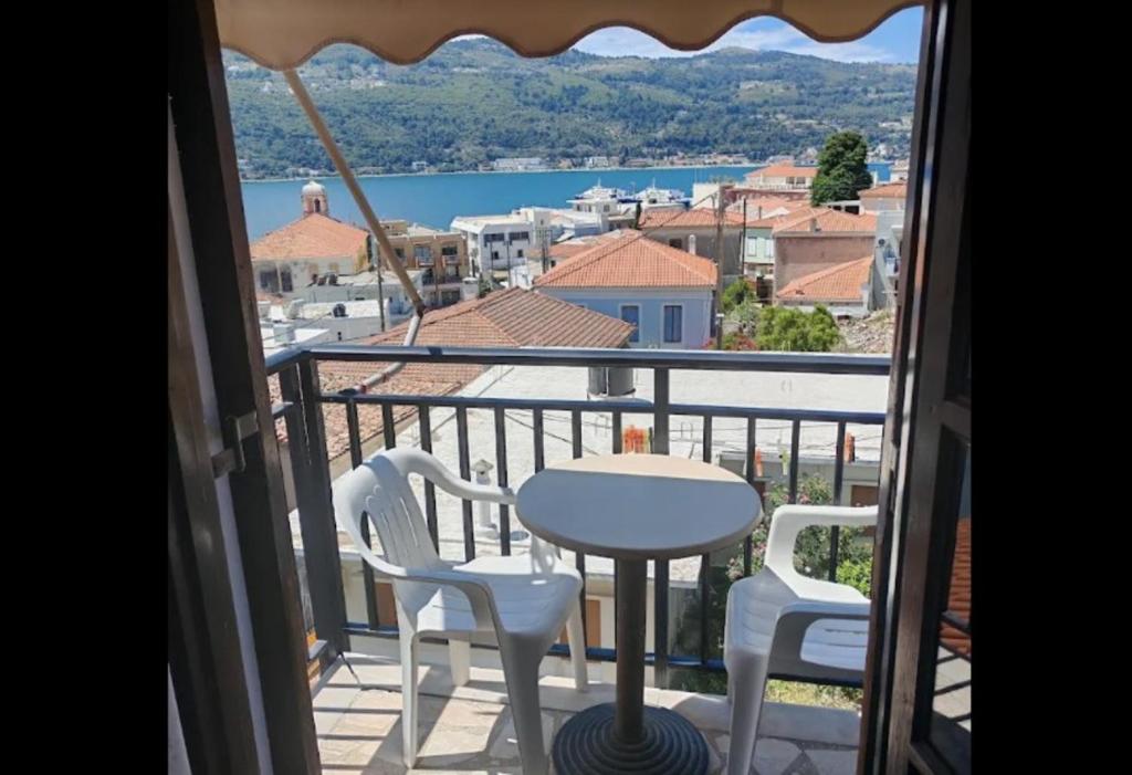 a view of a balcony with a table and chairs at samos town hostel in Samos